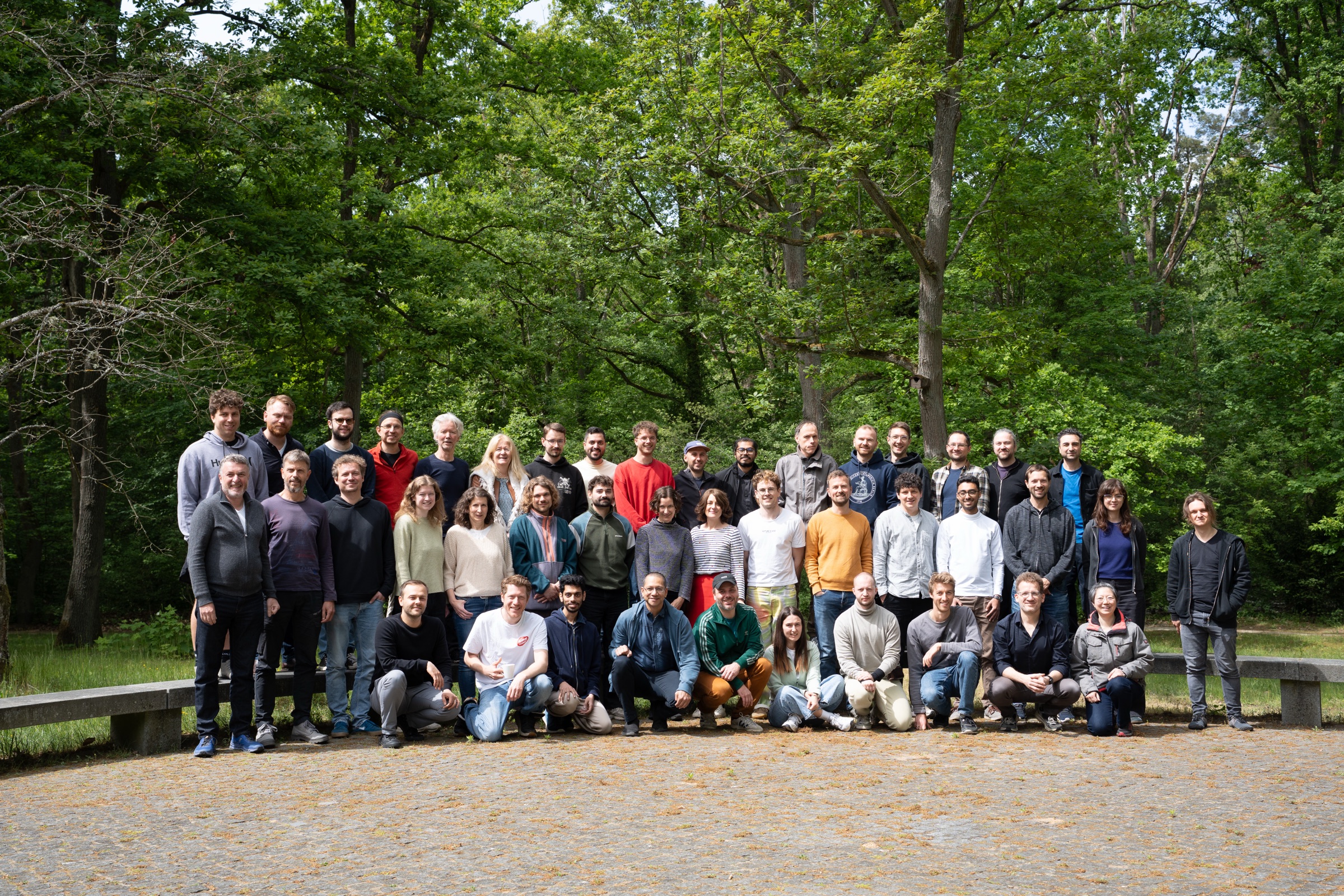 Group photo of the Summer School 2025 participants in front of a forest