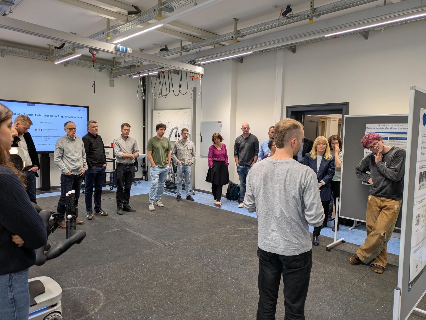 Participants of the research meeting listening to a presentation in the robotics lab