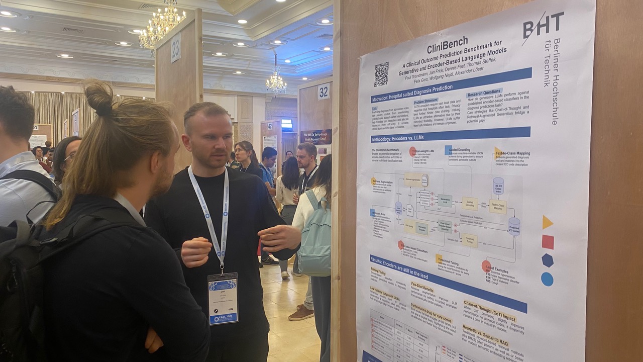 Jan Frick discussing the CliniBench poster with a visitor in the poster hall at EACL 2026